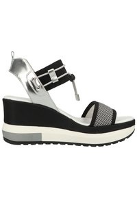 Wedge sandals with a black fabric upper, silver accents, and mesh detailing. Features a thick white sole with black tread for grip.