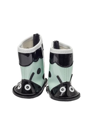 Bottes de pluie pour tout-petits conçues comme des coccinelles avec des couleurs noir, blanc et vert clair et des visages souriants sur les orteils.