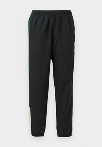 Black track pants with an elastic waistband, featuring green and beige side panels and a tapered leg design. Made from lightweight material.