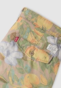 Tissu à imprimé floral de Levi's avec poche à rabat boutonnée, petite étiquette rouge Levi's et étiquette blanche Levi Strauss & Co.