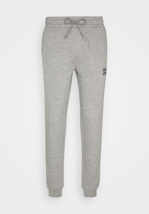 Grey sweatpants made from soft, fleece material. Features elastic waistband with drawstring, cuffed ankles, and a logo at the hip.