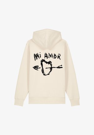Felpa con cappuccio color crema con una texture morbida. Presenta una stampa grafica nera con il testo "Mi Amor" e una freccia che circonda una forma a cuore.