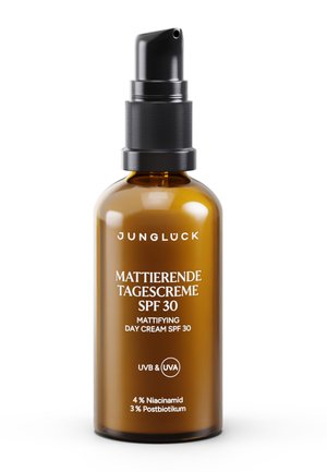 Brown glass pump bottle labeled Jungluck mattifying day cream with SPF 30, containing 4% niacinamide and 3% postbiotic.