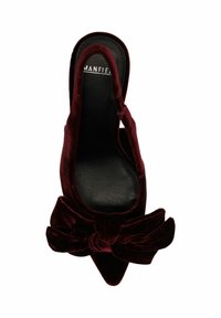 Burgundy velvet slingback shoe with a pointed toe and large bow detail at the front, featuring a black insole and smooth texture.