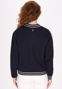 Maglione lavorato a maglia blu navy con finitura testurizzata, caratterizzato da un colletto e polsini a coste con righe bianche, e un logo discreto sul retro del collo.