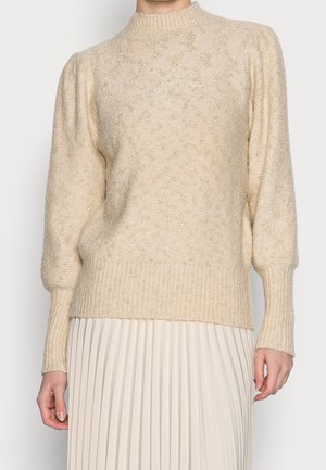 Beige gebreide trui met geribde manchetten en zoom, met een textuur en glinsterende accenten. Hoge halslijn en pofmouwen.