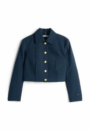 Navy cropped jacket with a collared neck, featuring six gold buttons down the front and a small logo on the sleeve. Smooth texture.