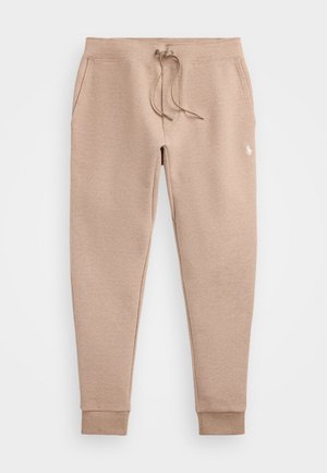 Beige joggebukser med snørelukning i taljen, sidelommer, ribkanter og lille syet logo på højre lår.