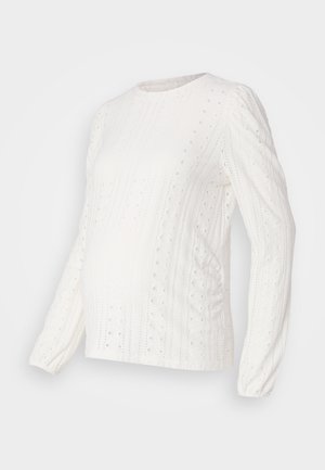 Fehér, hosszúujjú felső, texturált mintákkal, lyukacsos részletekkel, bordás mandzsettákkal és kerek nyakkivágással, kifejezetten várandós nők számára tervezve.