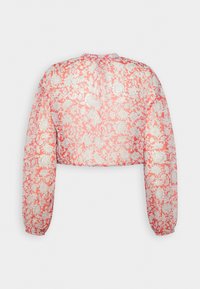 Blusa a maniche lunghe corsa con sovrapposizione di pizzo floreale bianco e polsini elasticizzati, mostrata da dietro su uno sfondo neutro.