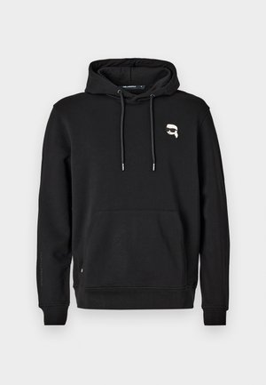 Schwarzer Hoodie mit einer Kängurutasche, einer Kapuze mit Kordelzug und Logo-Detail auf der linken Brust. Hergestellt aus weichem Stoff mit gerippten Bündchen und Saum.