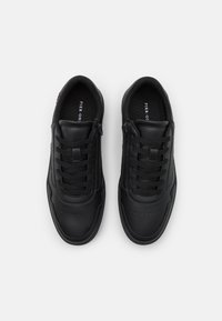 Black sneakers with a smooth synthetic upper, lace and zip closure, perforated design on the toe cap, flat rubber sole, and padded collar.
