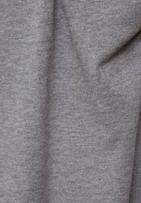 Tissu gris au toucher doux, présentant un motif de tricot fin. Le matériau semble léger et légèrement extensible.