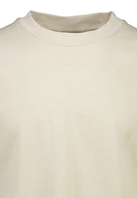 Vaaleanbeige puuvillashirtti, jossa on pyöreä kaula-aukko, teksturoitu kangas ja lyhyet hihat, ja siinä on sileä pintakuvio ja tasainen ompelu.