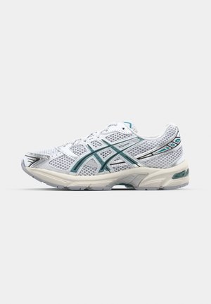 White athletic shoe with mesh upper, teal accents, and silver detailing. Features a cushioned sole and a streamlined silhouette.