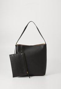 Black leather tote bag with a single long handle and a detachable zippered pouch. Smooth texture and gold-tone hardware accents.