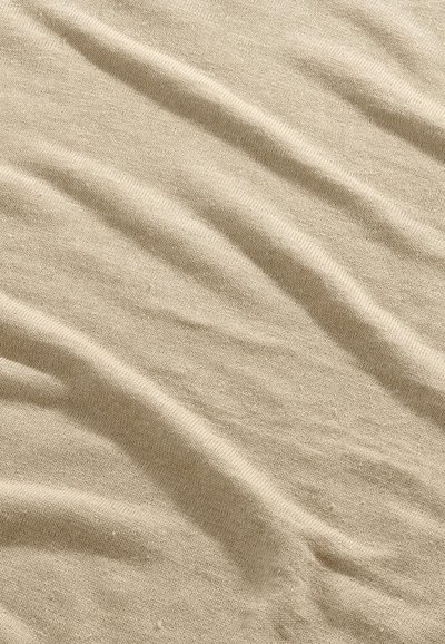 Beige soft fabric with fine knit texture and gentle folds creating subtle shadows and highlights.