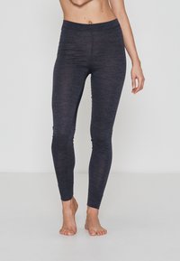 Mørkegrå, tætsiddende leggings lavet af blødt, strækbart materiale; har en høj talje og glat tekstur, der snævrer ind ved anklen.