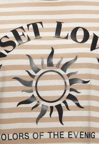 Beige and white striped t-shirt featuring a black sun graphic and the text "SUNSET LOVE." Soft cotton fabric, round neckline, and relaxed fit.