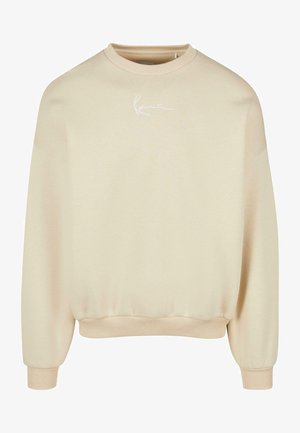 Béžová mikina s kulatým výstřihem, dlouhými rukávy a žebrovanými manžetami. Na hrudi se nachází bílé logo a má hladkou, měkkou strukturu.