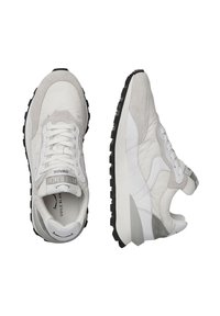 Sneakers bianchi e grigi che presentano una combinazione di materiali scamosciati e in pelle, una suola in gomma nera testurizzata e un logo prominente sulla linguetta.