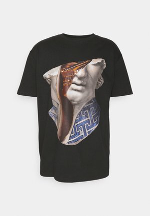 Black t-shirt featuring a graphic print of a fragmented classical statue with gold and blue detailing, showcasing a textured design.