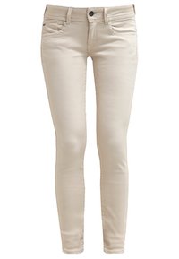 Jeans skinny beige hechos de una mezcla de algodón, con dos bolsillos frontales, un cierre de botón y una textura suave.