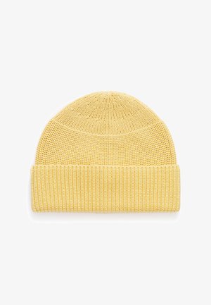 Geltona megzta kepurė su ribotu kraštu, pasižyminti tekstūruotu raštu ir apvalia viršūne. Lengva ir tampri medžiaga.