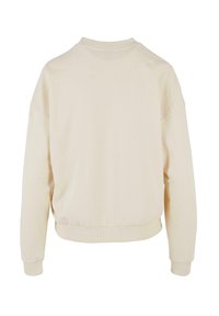 Beige Sweatshirt mit lockerer Passform, geripptem Rundhalsausschnitt und langen Ärmeln. Verfügt über einen verkürzten Saum und weichen, strukturierten Stoff.