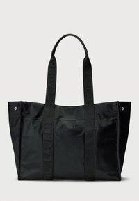 Black tote bag made of nylon, featuring two textured straps. Its design includes a smooth surface and metal snap details.