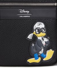 Black textured pouch featuring a cartoon Donald Duck design in sunglasses and a coat, with a silver zipper and branded labels.