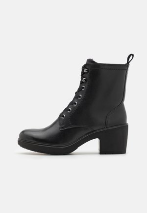 Black leather ankle boot with a rounded toe, lace-up front, metallic eyelets, and a sturdy block heel. Smooth texture with minimal accents.
