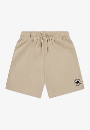 Beige cotton shorts with an elastic waistband and drawstring. Features a black star logo and text on the lower left side.