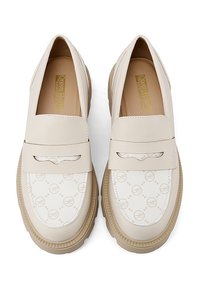 Mocassini crema con upper in pelle lucida, soletta texture e dettagli in tela stampata. Suola in gomma per aderenza; design minimalista.