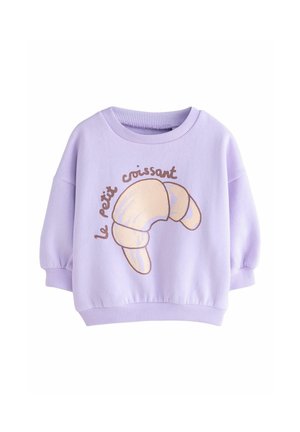 Light purple, oversized sweatshirt with a round neck. Features a croissant graphic and the text "le petit croissant" in brown. Ribbed cuffs.