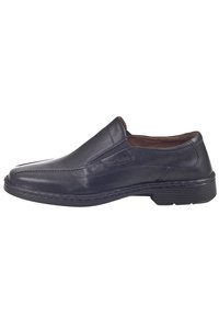 Sorte læder slip-on sko med en glat tekstur, rund tå, minimale syninger og en gummisål for godt greb.