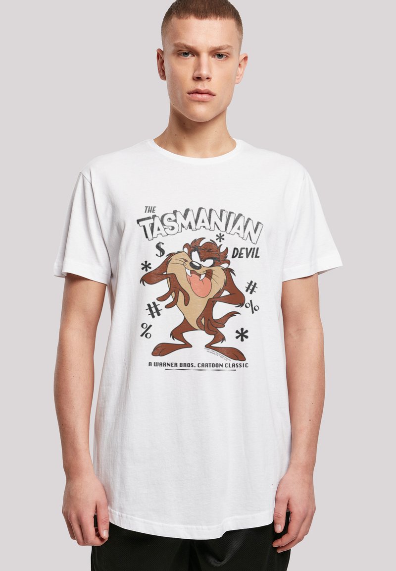 Hvit bomull T-skjorte med "The Tasmanian Devil" grafikk i brun og svart, samt lekne tekstelementer. Korte ermer, rund hals.