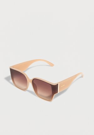 Beige, quadratische Sonnenbrille mit braunen Verlaufsgläsern und breiten Bügeln, auf der Seite mit ALDO gebrandet.
