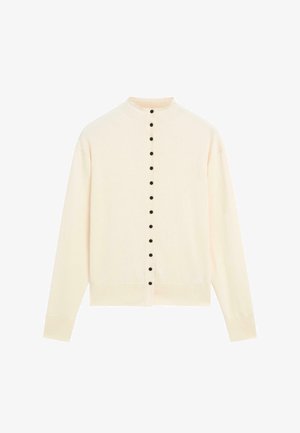 Ljus krämfärgad cardigan med hög krage, med en rad svarta knappar framtill och långa ärmar, tillverkad av mjukt stickat material.