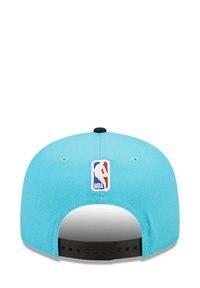Light blue baseball cap featuring an NBA logo patch on the back, adjustable black strap, and a smooth fabric texture.