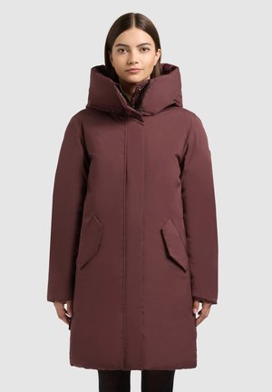 Maroon puffer coat with a high collar, zip closure, and two front pockets. Features a smooth texture and a knee-length design.