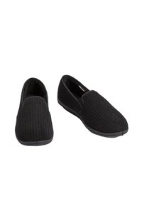 Scarpe slip-on nere con una texture rigata, tessuto morbido, punta arrotondata e suola flessibile. Design minimalista senza decorazioni.