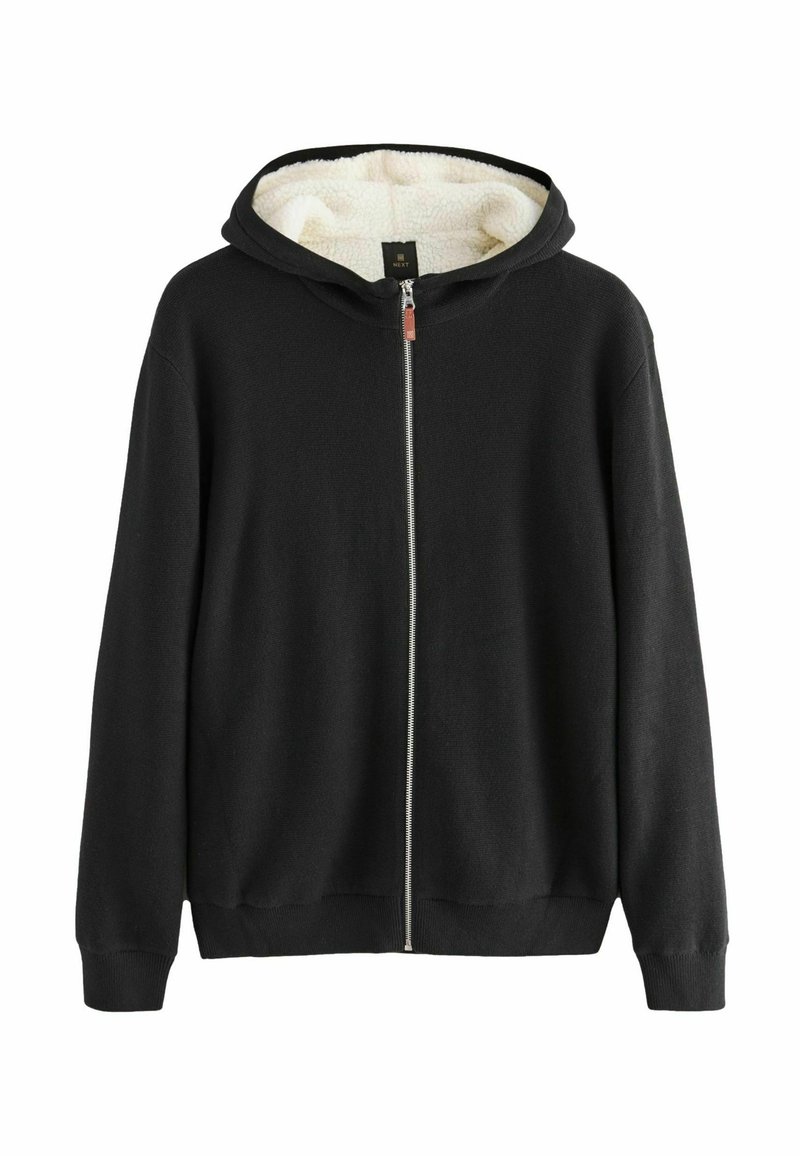 Mustha musta kapuutsiga, millel on kunstkarusnahast vooder, soonikuga varrukad ja äär; sisaldab hõbedast tõmblukk ja peenelt tekstureeritud kangast.