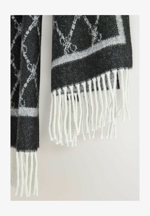 Wollschal mit einem schwarz-weißen Muster und Fransen an den Kanten. Das Design umfasst ein geometrisches Motiv und hat eine weiche, strukturierte Oberfläche.