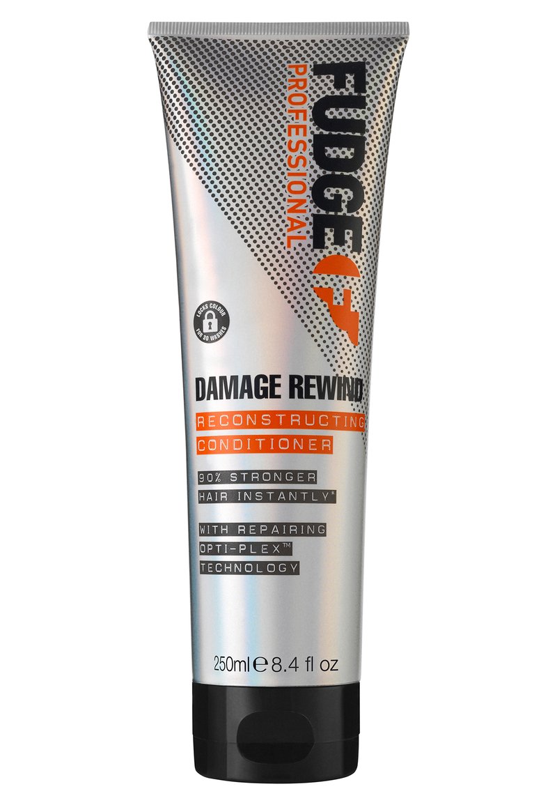 Zilveren knijptube met zwarte dop, etiket "Fudge Professional Damage Rewind" in oranje en zwart, met stippenpatroon en productdetails. 250ml.