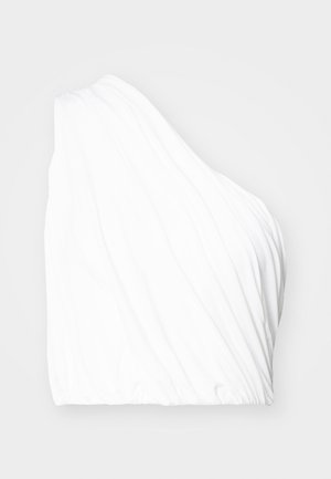 Asimetriška balta palaidinė, pagaminta iš lengvos medžiagos, pasižyminti drapiruota tekstūra ir elastingu apačiu. Lygus paviršius su minkštais, tekantiems linijomis.