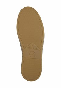 Suola di scarpa in gomma color beige con un motivo testurizzato. Presenta un logo circolare e accenti esagonali per una maggiore aderenza. I bordi sono lisci e leggermente curvi.
