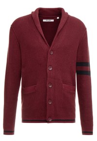 Cardigan lavorato a maglia color mogano con collo a scialle, cinque bottoni frontali, due tasche e dettagli a righe nere sulla manica sinistra. Tessuto morbido.