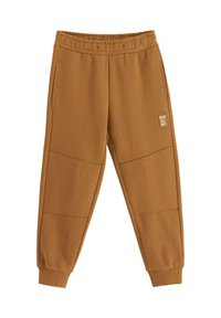 Braune Sweatpants aus weichem Stoff mit einem gerippten Bund, seitlichen Taschen und strukturierten Akzenten an den Unterschenkeln. "PLAY ALL DAY"-Logo vorhanden.