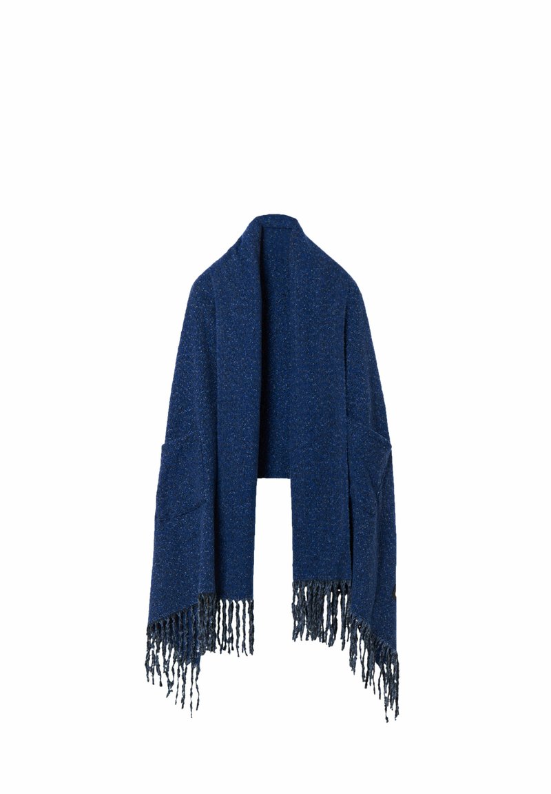 Dark blue knitted shawl with a textured finish, featuring long fringes along the bottom and open sides. No fastenings, designed for layering.
